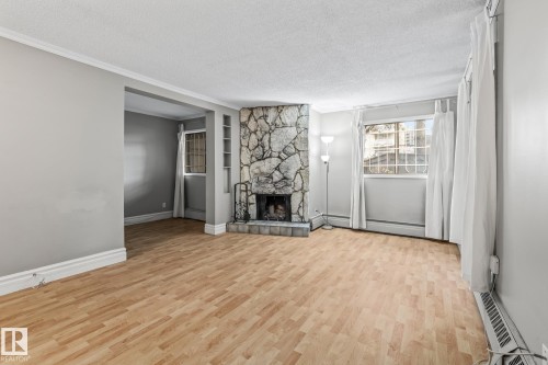 G7 10148 118 Street, Edmonton, AB - Indoor Photo Showing Living Room With Fireplace