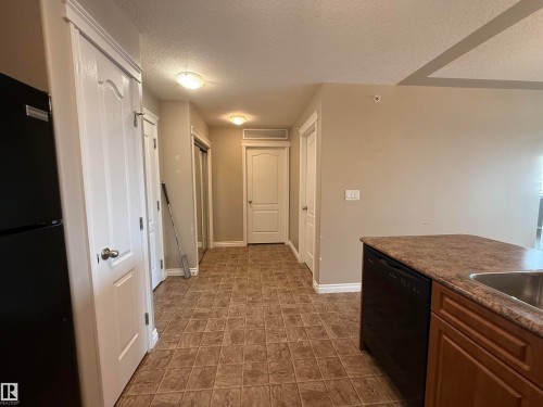 Hallway with a textured ceiling and baseboards - 423 99 Westerra Manor, Stony Plain, AB - Indoor