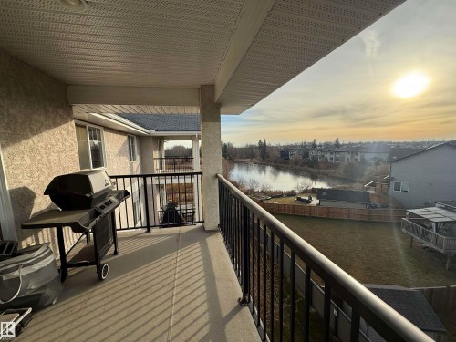 Balcony at dusk with a grill - 423 99 Westerra Manor, Stony Plain, AB - Outdoor With Balcony With Exterior
