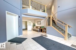 Common area with a high ceiling, stairs, and recessed lighting - 
