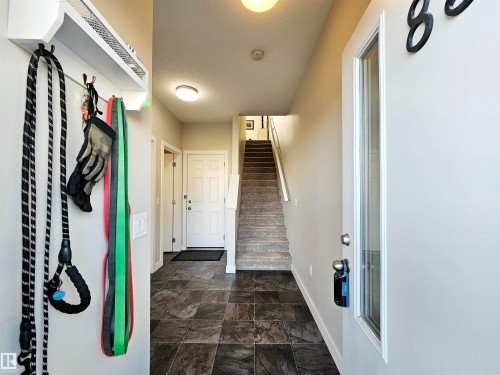 Mudroom featuring stone finish floors and baseboards - 83 600 Bellerose Drive, St. Albert, AB - Indoor Photo Showing Other Room