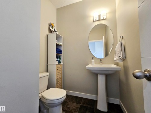 Half bath featuring baseboards and toilet - 83 600 Bellerose Drive, St. Albert, AB - Indoor Photo Showing Bathroom