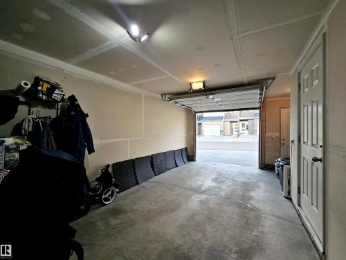 Garage featuring a garage door opener - 83 600 Bellerose Drive, St. Albert, AB - Indoor Photo Showing Garage