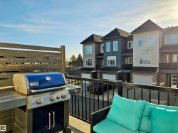 Balcony with area for grilling, a residential view, and an outdoor living space - 