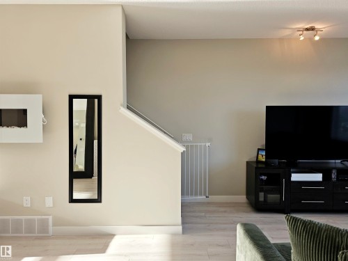 Living area featuring light wood-type flooring and stairway - 83 600 Bellerose Drive, St. Albert, AB - Indoor