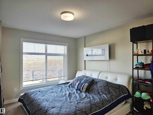 Carpeted bedroom featuring a textured ceiling - 83 600 Bellerose Drive, St. Albert, AB - Indoor Photo Showing Bedroom