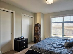 Bedroom with carpet floors and multiple closets - 