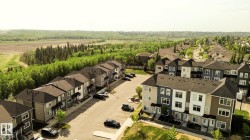 Contemporary townhome community featuring diverse exterior color palettes and varied architectural details - 
