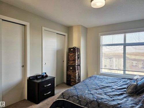 Bedroom with carpet floors and multiple closets - 83 600 Bellerose Drive, St. Albert, AB - Indoor Photo Showing Bedroom