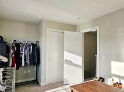 Bedroom with light carpet and a closet - 