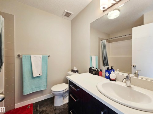 Full bathroom featuring a textured ceiling, vanity, and a shower with curtain - 83 600 Bellerose Drive, St. Albert, AB - Indoor Photo Showing Bathroom