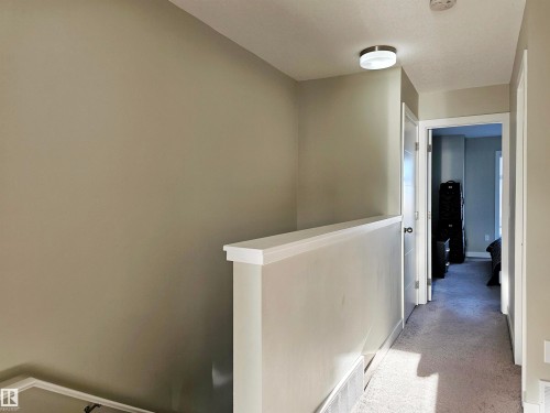 Hallway featuring light carpet and an upstairs landing - 83 600 Bellerose Drive, St. Albert, AB - Indoor Photo Showing Other Room
