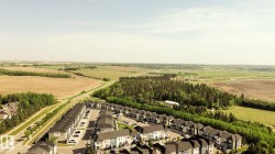 Aerial perspective of a multi-unit residential development featuring consistent architectural styling - 
