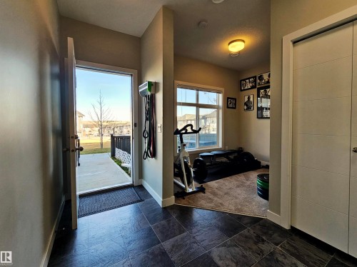 Foyer with baseboards and stone tile flooring - 83 600 Bellerose Drive, St. Albert, AB - Indoor Photo Showing Other Room