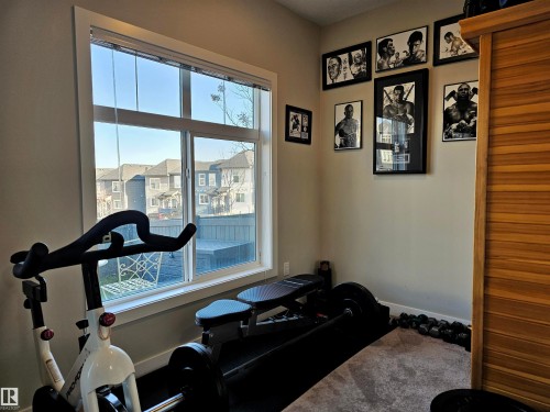 Workout room featuring baseboards and a residential view - 83 600 Bellerose Drive, St. Albert, AB - Indoor Photo Showing Other Room
