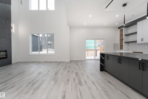 145 Graybriar Drive, Stony Plain, AB - Indoor Photo Showing Kitchen With Fireplace