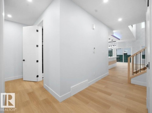 Hallway with stairway, recessed lighting, and light wood-style flooring - 15419 20 Street, Edmonton, AB - Indoor Photo Showing Other Room