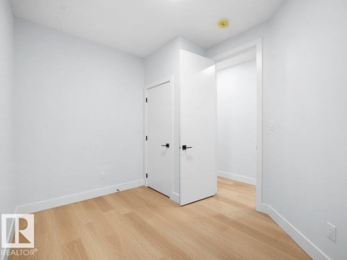 Empty room with light wood-style flooring - 15419 20 Street, Edmonton, AB - Indoor Photo Showing Other Room