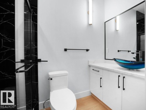 Bathroom featuring a marble finish shower, vanity, and light wood-type flooring - 15419 20 Street, Edmonton, AB - Indoor Photo Showing Bathroom