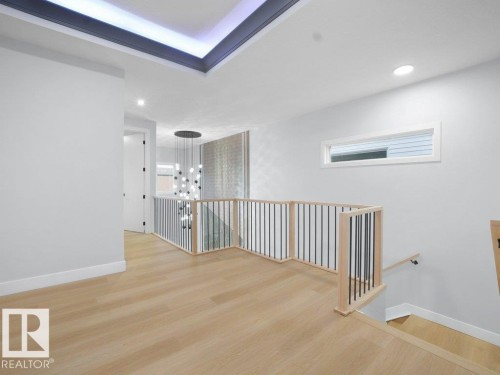 Unfurnished room with light wood-style floors, a chandelier, and recessed lighting - 15419 20 Street, Edmonton, AB - Indoor Photo Showing Other Room