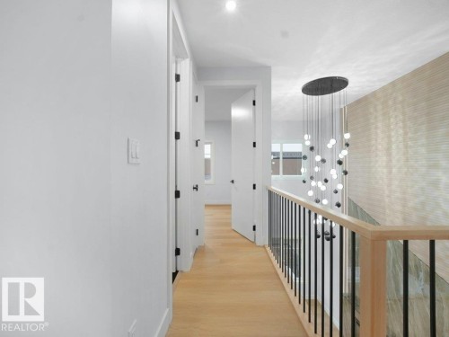 Corridor with light wood-style flooring and an upstairs landing - 15419 20 Street, Edmonton, AB - Indoor Photo Showing Other Room