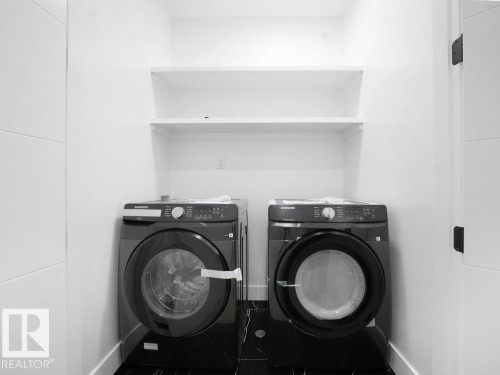 Washroom with washer and dryer and tile patterned floors - 15419 20 Street, Edmonton, AB - Indoor Photo Showing Laundry Room