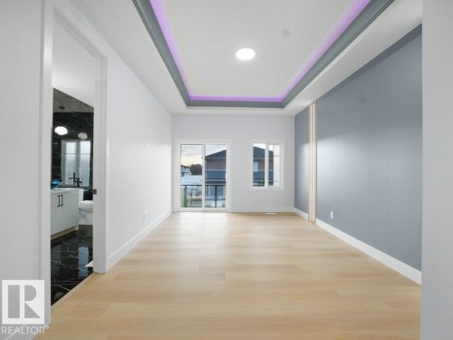 Hall featuring a raised ceiling and light wood finished floors - 15419 20 Street, Edmonton, AB - Indoor Photo Showing Other Room