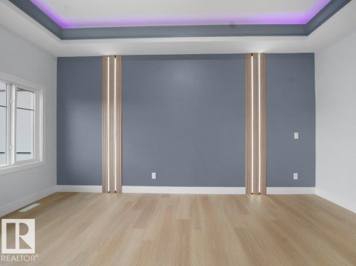 Unfurnished room with light wood-type flooring and a raised ceiling - 15419 20 Street, Edmonton, AB - Indoor Photo Showing Other Room
