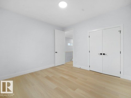 Unfurnished bedroom with light wood-style flooring and a closet - 15419 20 Street, Edmonton, AB - Indoor Photo Showing Other Room