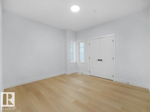 Unfurnished bedroom with light wood-type flooring and a closet - 15419 20 Street, Edmonton, AB - Indoor Photo Showing Other Room
