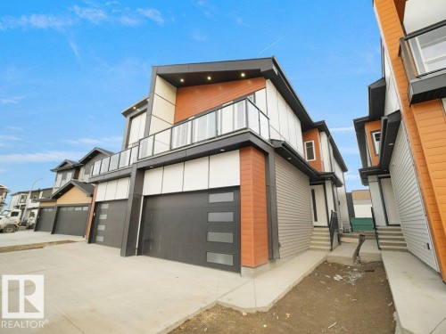 Contemporary house with a balcony, concrete driveway, an attached garage, and entry steps - 15419 20 Street, Edmonton, AB - Outdoor