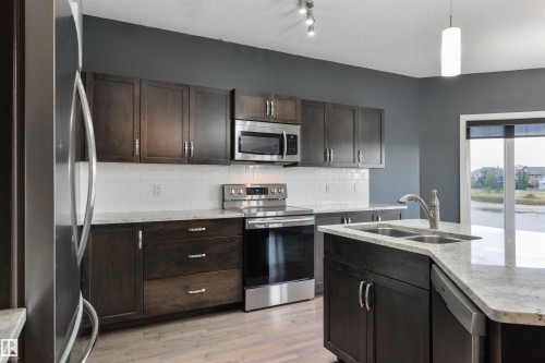 63 Dalquist Bay, Leduc, AB - Indoor Photo Showing Kitchen With Double Sink With Upgraded Kitchen