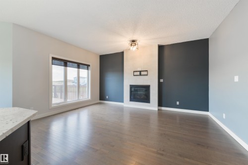 63 Dalquist Bay, Leduc, AB - Indoor Photo Showing Living Room With Fireplace