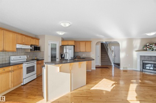 1263 Mcallister Way, Edmonton, AB - Indoor Photo Showing Kitchen With Fireplace
