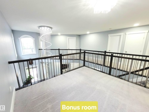 Corridor featuring carpet, a chandelier, and recessed lighting - 1357 Watt Drive, Edmonton, AB - Indoor Photo Showing Other Room