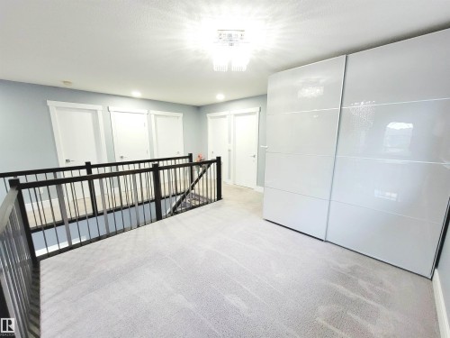 Hallway featuring light carpet, an upstairs landing, and recessed lighting - 1357 Watt Drive, Edmonton, AB - Indoor Photo Showing Other Room