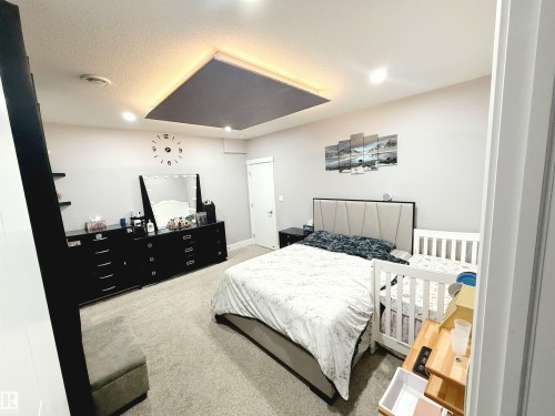 Bedroom with light carpet, a textured ceiling, and recessed lighting - 1357 Watt Drive, Edmonton, AB - Indoor Photo Showing Bedroom