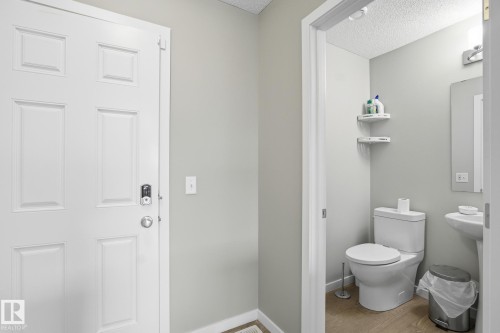 Bathroom featuring a textured ceiling and light wood-type flooring - 893 Ebbers Crescent Nw, Edmonton, AB - Indoor Photo Showing Bathroom