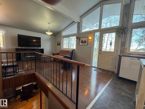 Entrance foyer with dark wood finished floors, high vaulted ceiling, healthy amount of natural light, and beam ceiling - 4707 53 Street, Athabasca Town, AB - Indoor Photo Showing Other Room