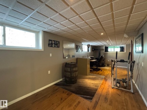 Below grade area featuring an office area and wood finished floors - 4707 53 Street, Athabasca Town, AB - Indoor