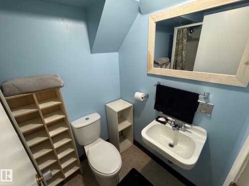 Bathroom with toilet and curtained shower - 4707 53 Street, Athabasca Town, AB - Indoor Photo Showing Bathroom