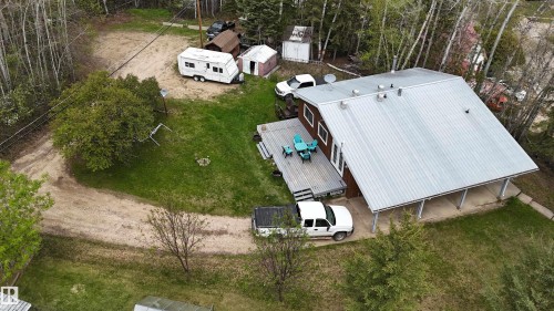 Single-story residence featuring a brown exterior, a metallic pitched roof, and a covered patio area - 4707 53 Street, Athabasca Town, AB - Outdoor