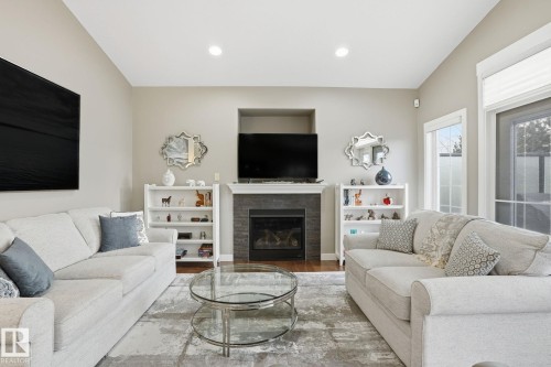 12 3090 Cameron Heights Way, Edmonton, AB - Indoor Photo Showing Living Room With Fireplace