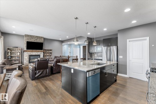 102 3510 Ste. Anne Trail, Rural Lac Ste. Anne County, AB - Indoor Photo Showing Kitchen With Fireplace With Upgraded Kitchen