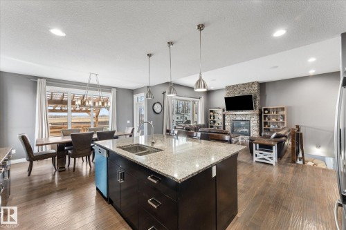 102 3510 Ste. Anne Trail, Rural Lac Ste. Anne County, AB - Indoor Photo Showing Kitchen With Fireplace With Double Sink With Upgraded Kitchen
