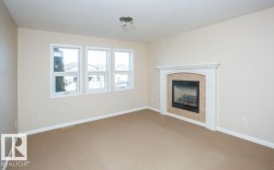 Unfurnished living room with a fireplace and carpet floors - 