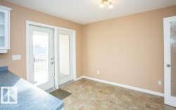 Doorway to outside featuring baseboards - 