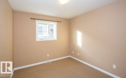 Carpeted empty room featuring baseboards - 