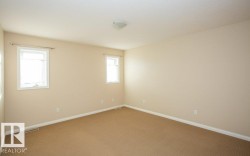 Carpeted empty room featuring baseboards - 