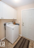 Laundry room featuring washer / clothes dryer and cabinet space - 